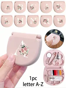 A pink sewing tool box decorated with pink floral patterns and white letters A-Z, a portable mini sewing set - foldable, containing DIY sewing supplies and accessories, suitable for travelers and emergency clothing fasteners, Sewing Kit