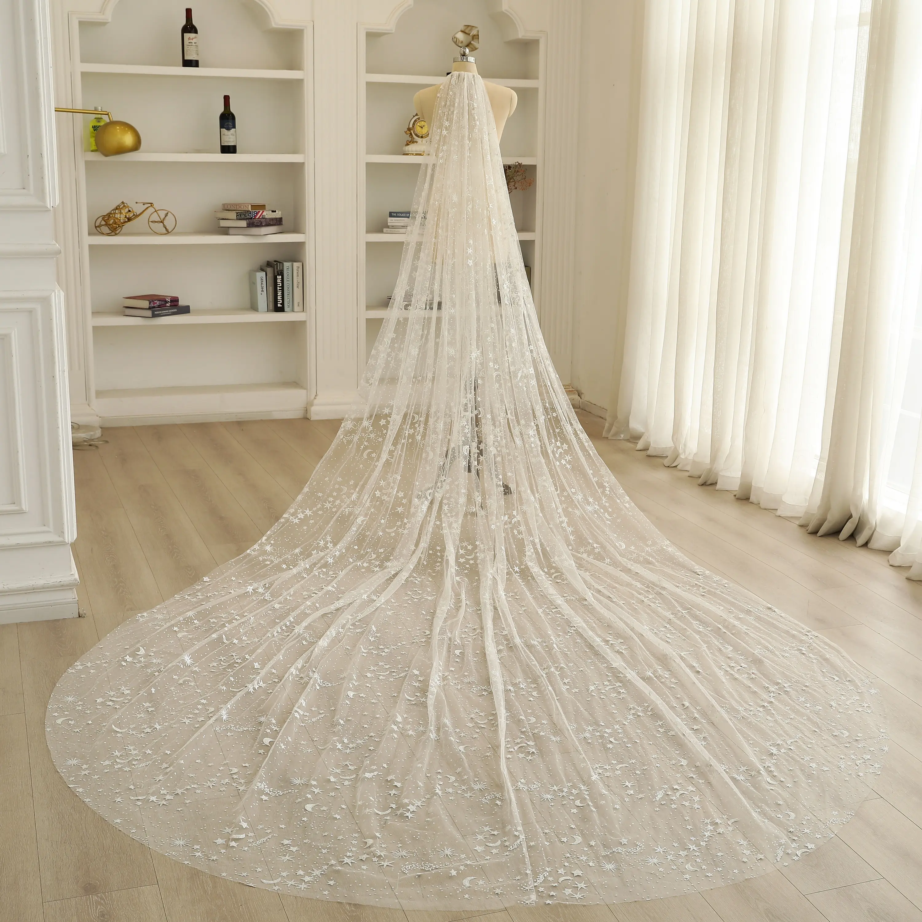 Starry sky transparent mesh veil with shimmering silver star and moon patterns; a romantic and exquisite wedding veil.
