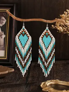 This hand-woven tassel earring, Statement Earrings, features a Bohemian style, Bohemian Inspiration, with a retro blue and white heart-shaped gradient design and geometric tassel patterns. It is versatile for women's daily wear, parties, and banquets
