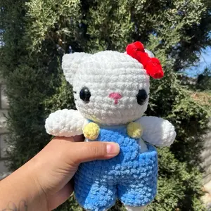 Crocheted white cat in overalls