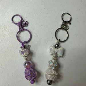 Live Claim Only beatable keychain bars with floral and bow charms for stylish accessory