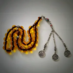 prayer 33 bead necklace, or tasbih, with amber-colored beads.