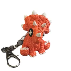 Cute Knitted Triceratops Keychain - Orange Knit Design with White Accents and Metal Clip Attachment