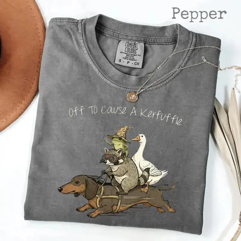 Comfort Colors Space Raccoon T-Shirt featuring a funny cosmic raccoon design, chaotic vibes, spooky gamer gift, and playful animal tee style for all.