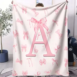 Light pink blanket with letter and bowknot print,Bowknot design blanket,Flannel blanket, soothing and charming,A comfortable and soft casual gift,Ideal as a car blanket,Easy to carry,Multiple styles available,Personalized Flannel Blanket