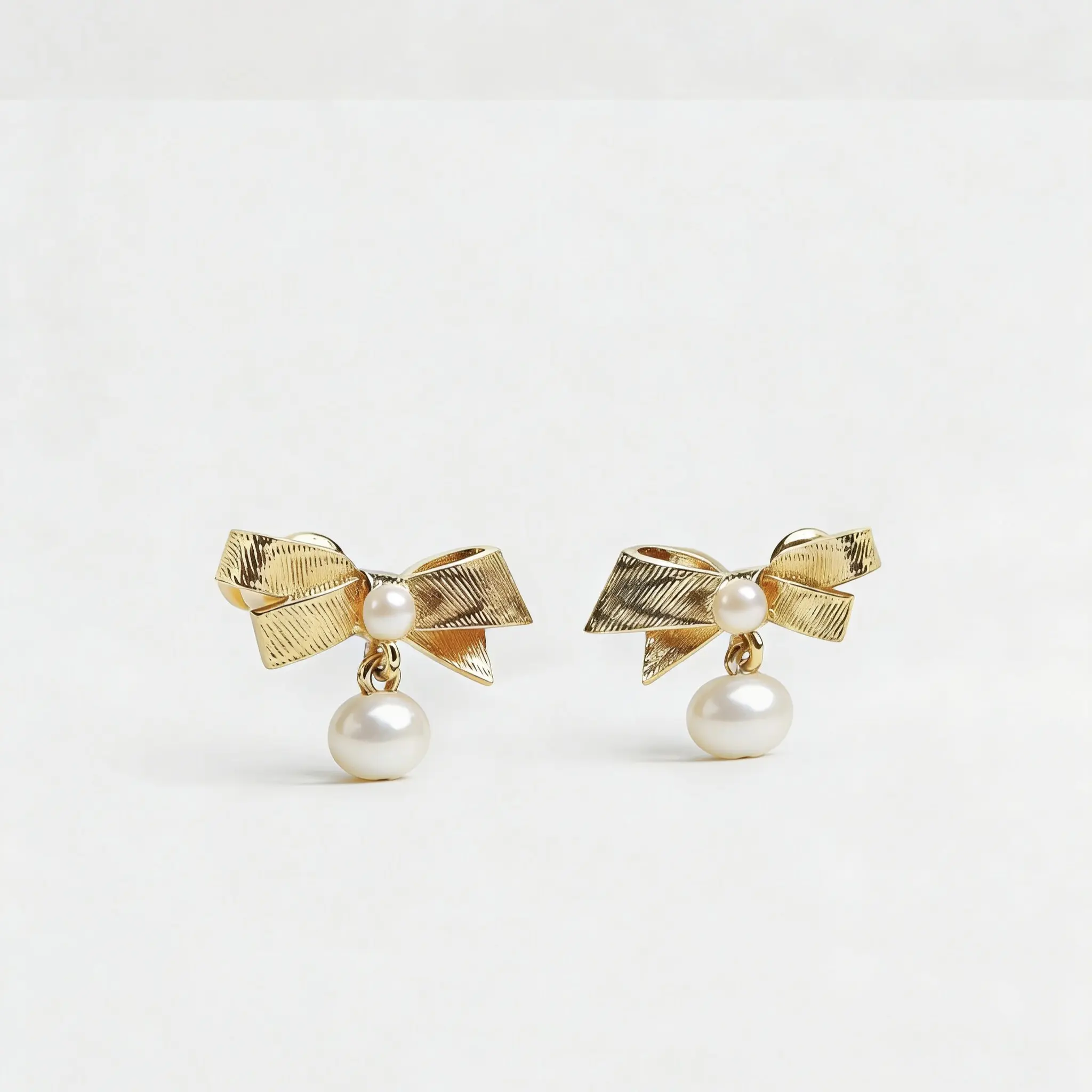 Gold-embroidered pearl-patterned bow earrings