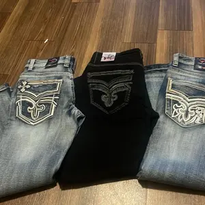 Mid Wash Blue Star Age Denim Jeans with Distressed Look and Embroidered Pocket Design