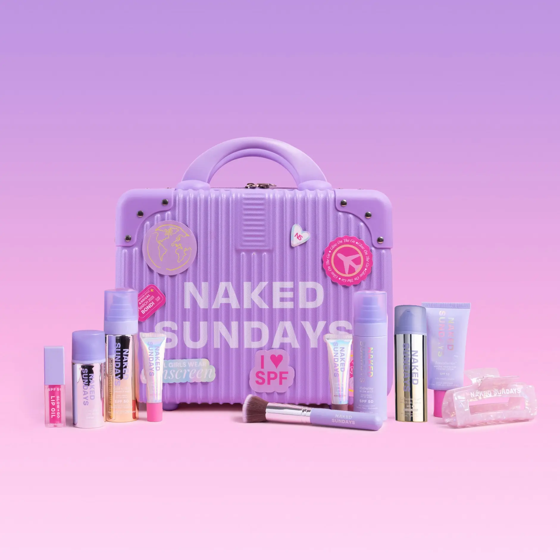 First Class Jetsetter Beauty Bundle Kit - Mini Exclusive Pink or Lilac Suitcase plus Naked Sundays bestselling SPF and Skincare products  (SAVE 40%)