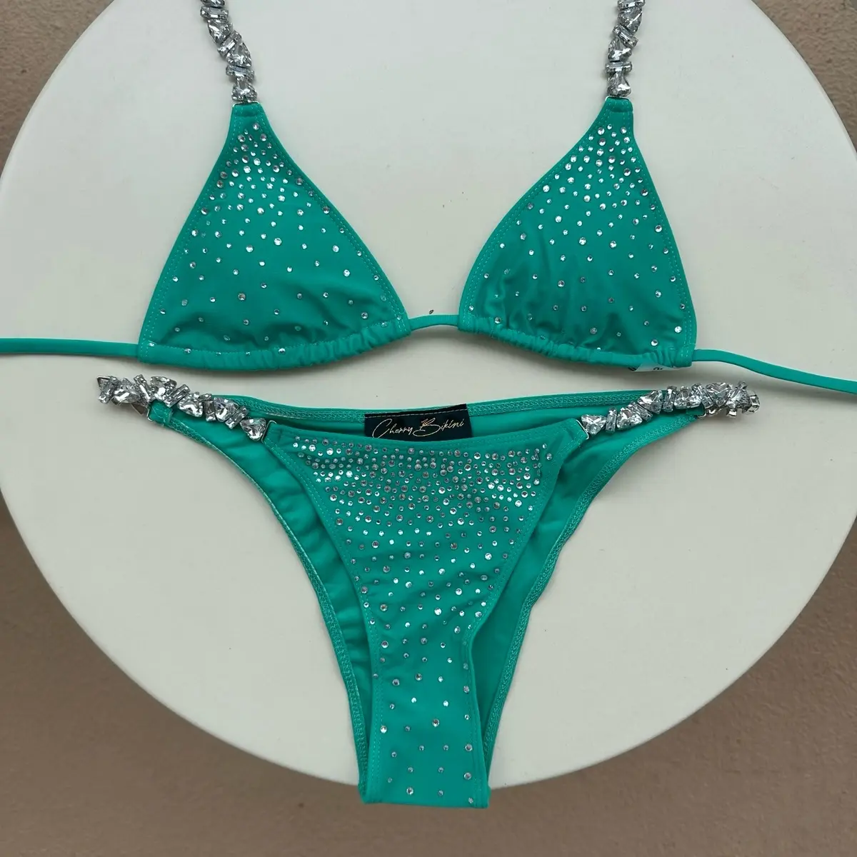 Emerald Green Swimwear by Cherry Bikini - Featuring padded triangle top, embedded with crystals and rhinestones on the neckties, amd high-waisted cheeky bottoms with crystals and rhinestones - for a stunning, luxurious fashionable look at the beach, pool