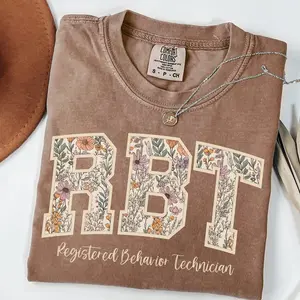 Comfort Colors RBT Tee – Cute Floral Design for ABA Therapists and Techs, RBT Comfort Colors Shirt – Autism Awareness T-Shirt with Varsity Font, ABA Therapist Comfort Colors Shirt – Floral RBT Tee for Autism Support Teams