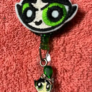 Blingy Badge Reel with Green Eyes and Green Gemstone Charm