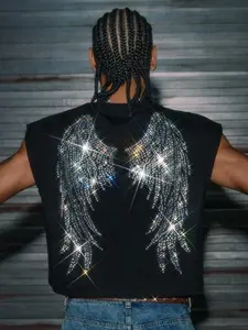 A cropped, wide-strap tank top featuring heat-pressed rhinestone embellishments and a unique, stylish wing motif on the back. Versatile enough for a wide range of occasions—from everyday wear to parties—this piece is a favorite among fashion influencers.