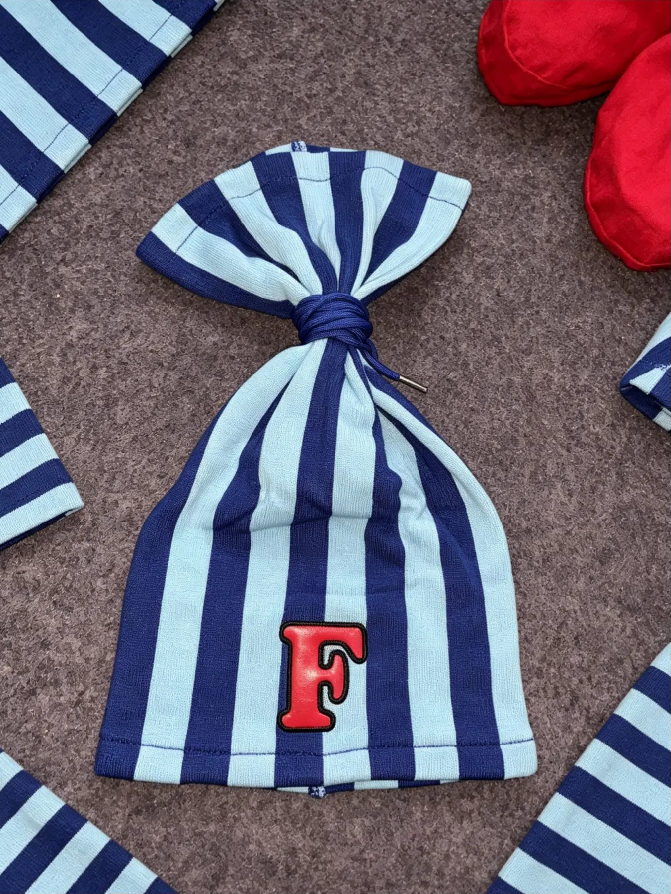 Unisex Striped Warm Hat with Knot Top and Letter F Embroidery, Y2K Street Fashion Accessory, Headwear for Men and Women