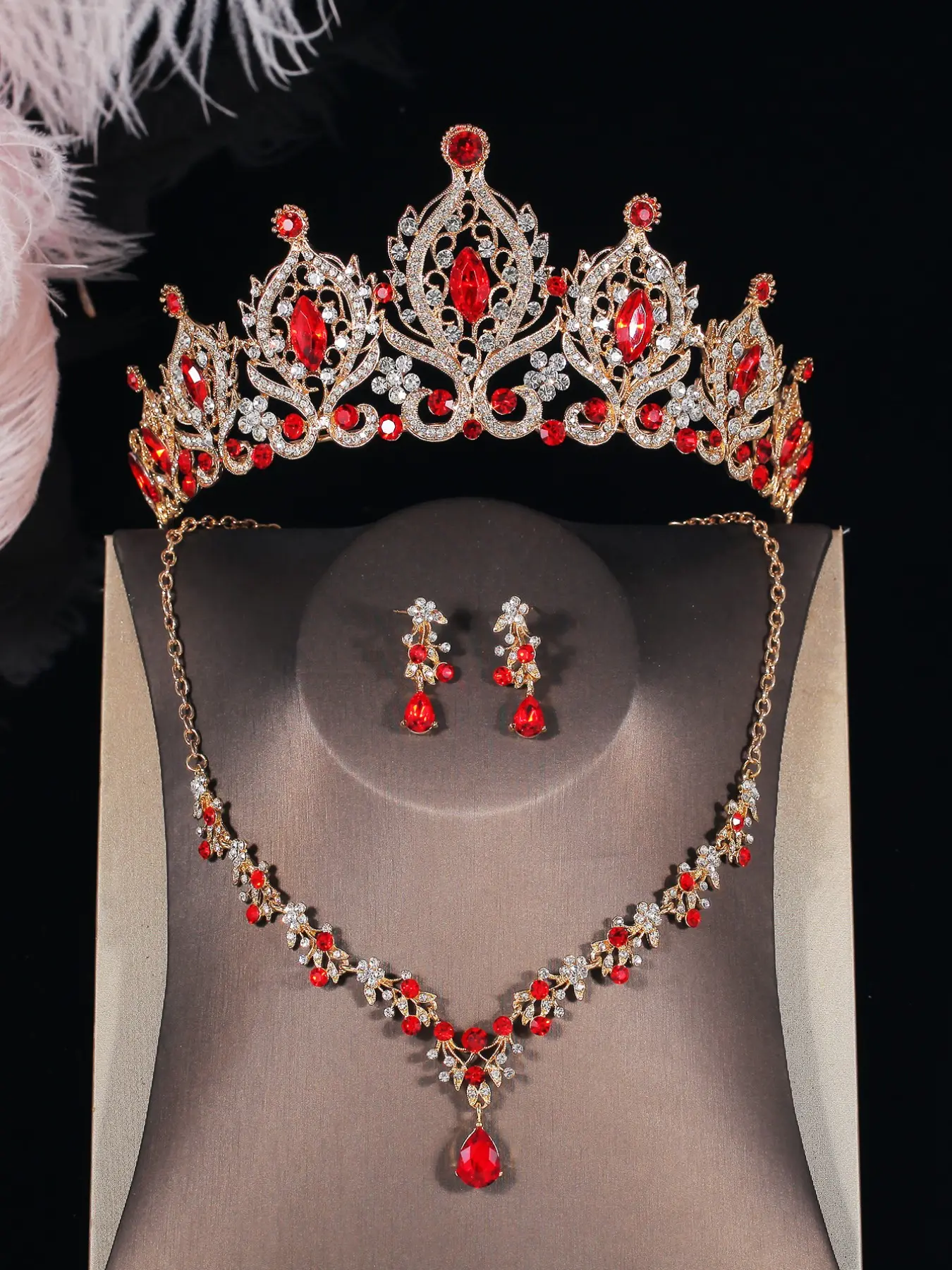A set of red and elegant bridal accessories including a crown, crystal-encrusted necklace, and earrings, suitable for wedding dresses and also perfect for wedding parties, dances, and prom events.
