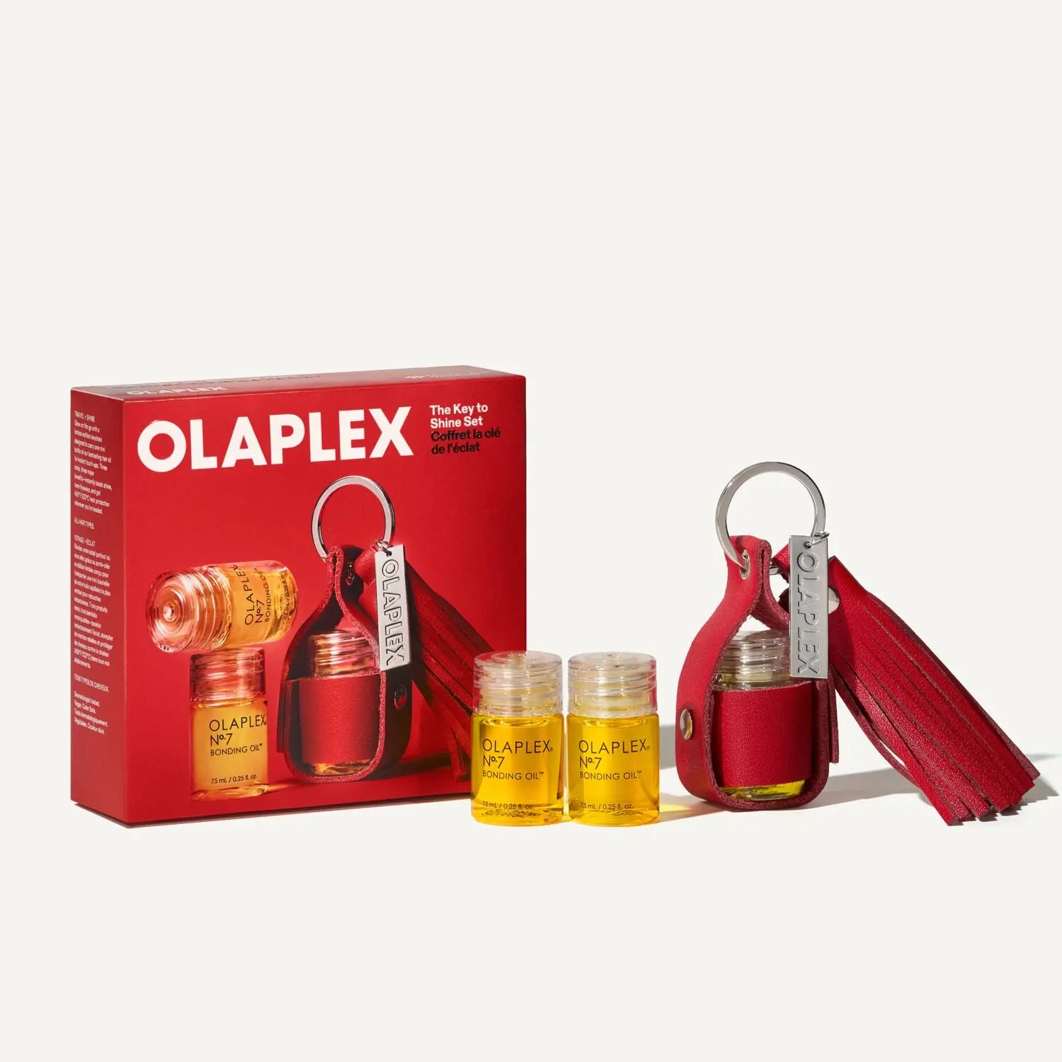 OLAPLEX - THE KEY TO SHINE SET - A trio of mini OLAPLEX Nº.7 BONDING OILS plus a limited-edition keychain for effortless, high-shine hair that travels with you.