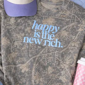 United Monograms Women's Casual Long Sleeve Comfy Camo Print Puff 'Happy is the New Rich' Hideaway Crewneck, Layer-Friendly Top