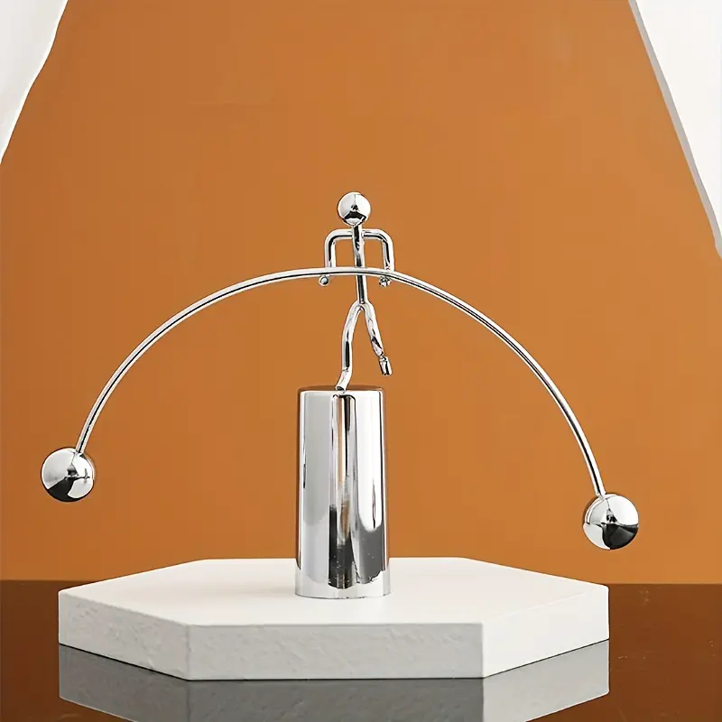 A Creative Newton Physics Ornament Featuring a Metal Iron That Spins on One Foot, Balanced with a Durable Plastic Base, Requires No Electricity, Making It a Great Stress-Relief Decoration for Home Or Office Desks, Perfect As a Holiday Gift