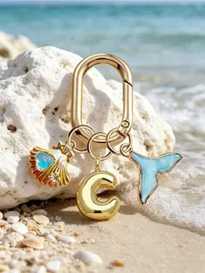 Golden bubble letter A-Z keychain, beach ocean style decorated with mermaid tail, shell and heart pendants. Elegant bag charm for girls, mermaid lovers and summer enthusiasts.