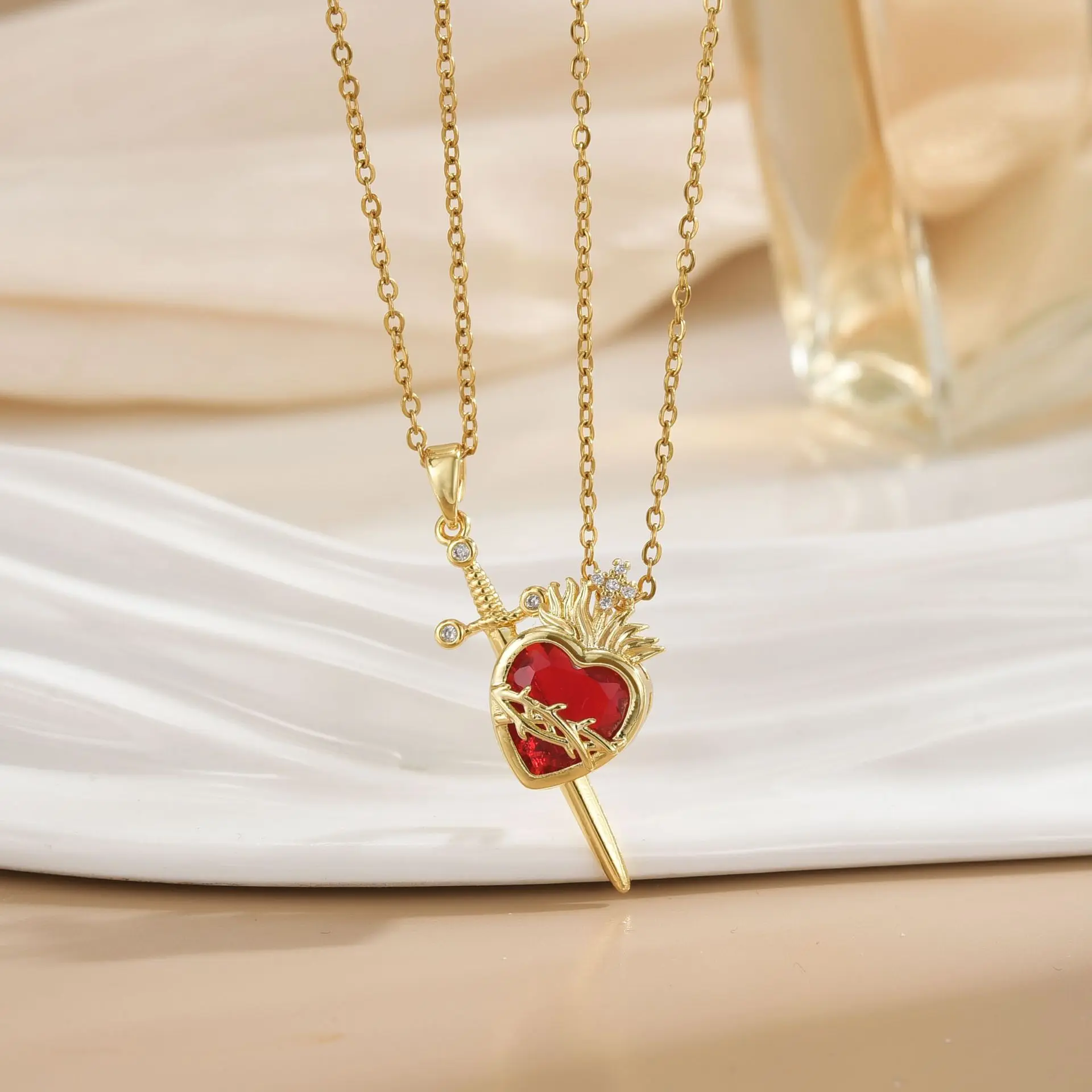 Royal Monaco Cuban Necklace, Italian Jewelry for Men & Women, Gift for Fashion Lovers   This stylish sword and heart pendant necklace features a vibrant red crystal inlay, crafted with gold-toned metal for a bold, romantic look. Ideal for everyday wear,