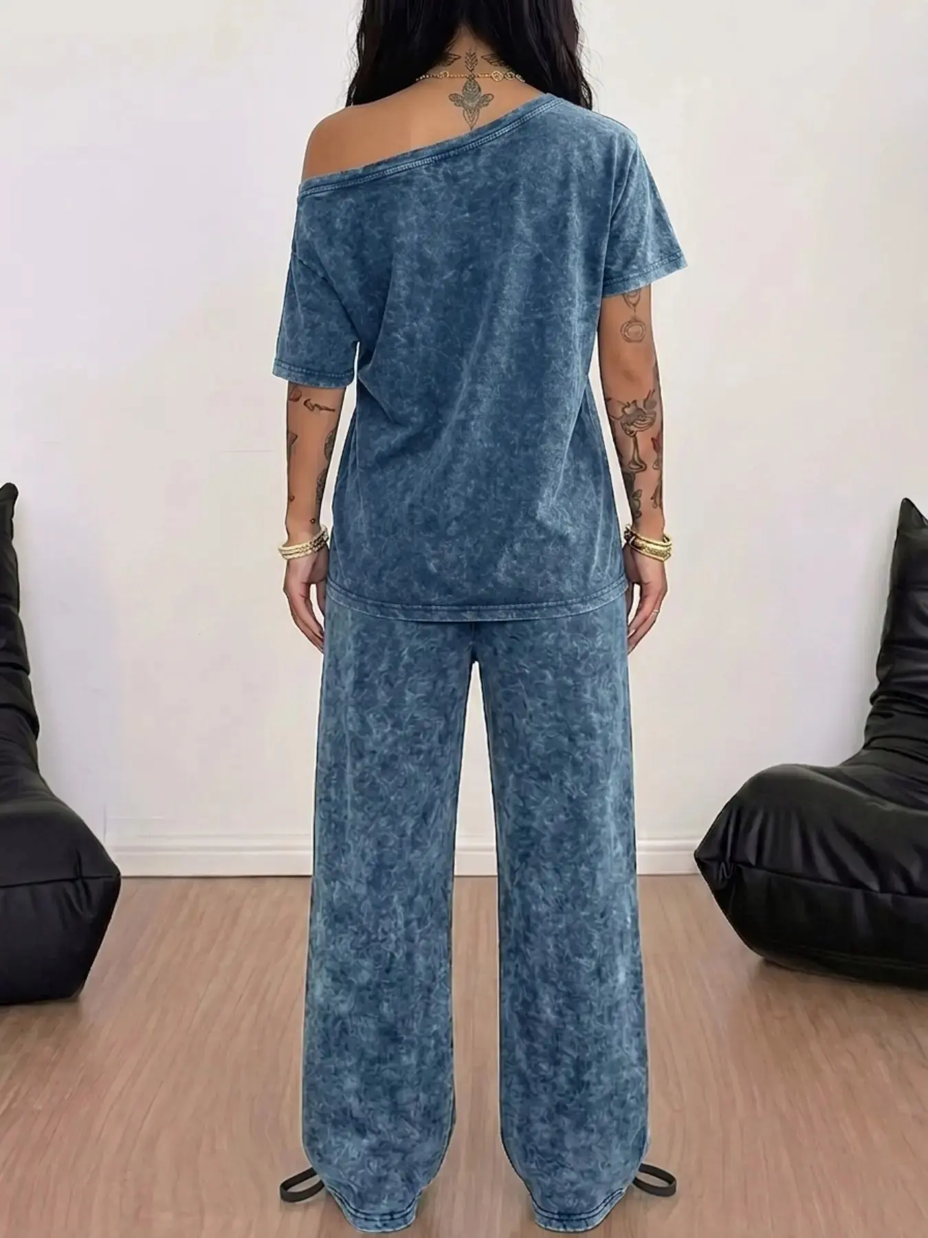 A leopard-print set in washed cotton featuring an off-the-shoulder, wide-neck design that highlights the collarbones and a bold 'NYC' leopard print, the loose-fitting T-shirt pairs with wide-leg drawstring trousers to flatter the silhouette, Clothes