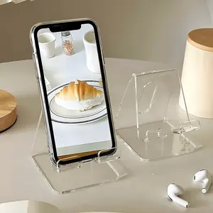 A one-piece multi-functional desktop Cellphone Holder Clear - featuring a non-slip base compatible with smartphone/tablet charging, an adjustable book/journal holder, suitable for office settings, and a space-saving phone holder