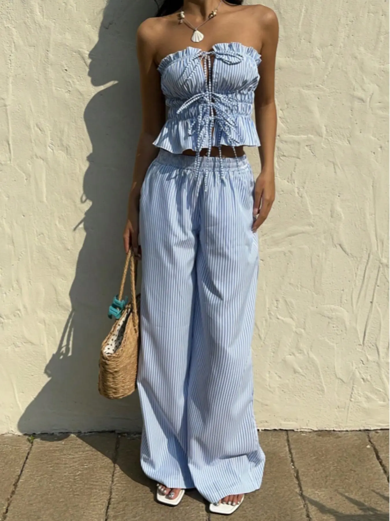 2 piece women's suit with a striped pleated waist top and trousers