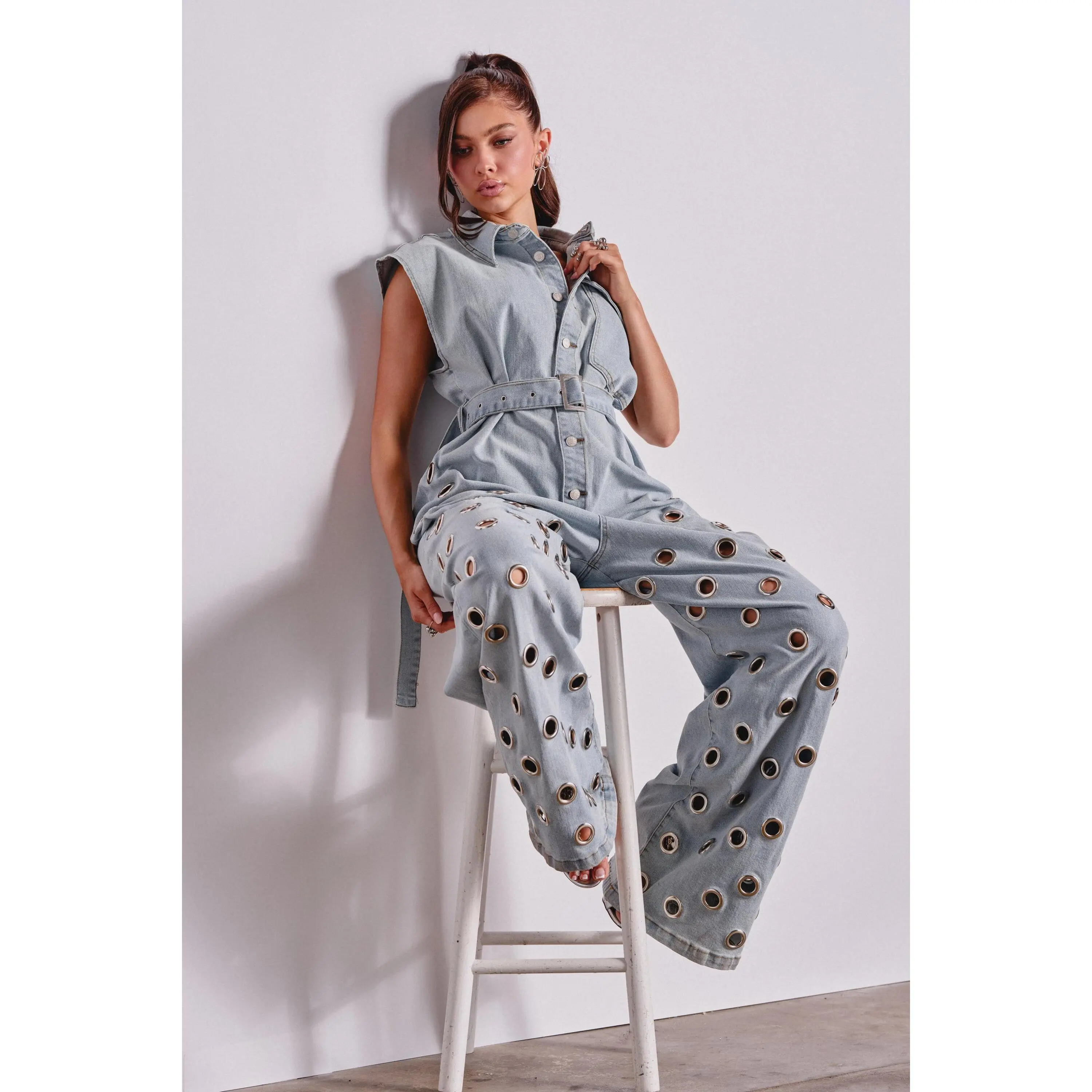 PLAY YOUR CARDS RIGHT DENIM JUMPSUIT WITH GROMMETS IN LIGHT WASH