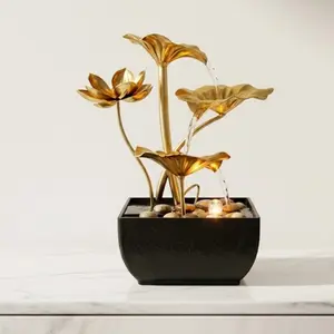 One light luxury gold lotus metal tabletop flowing fountain—minimalist Zen design inspired by nature, faux mountain decor ornament that helps relieve stress; suitable for entryways and counters, also ideal as a home or office gift. Flowing water ornament