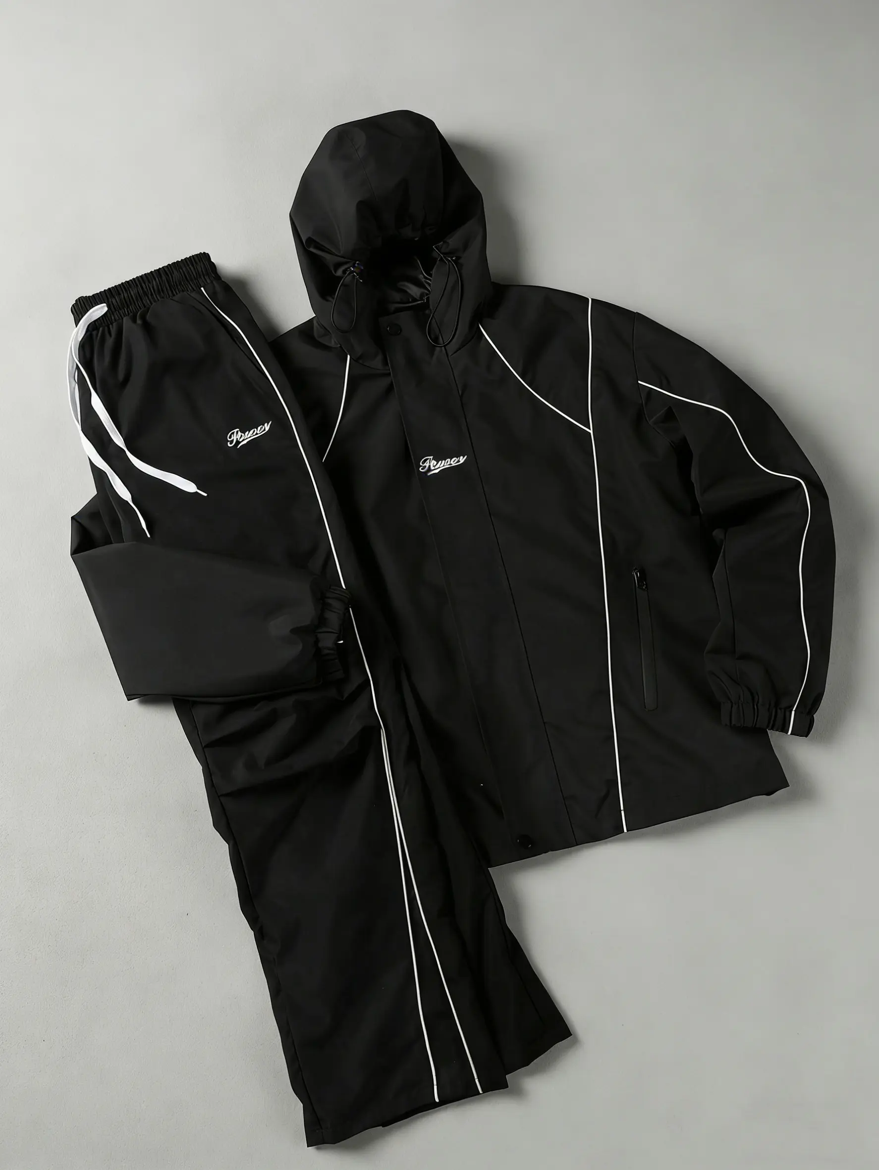 American high-street windproof two-piece set — hooded jacket + long pants, featuring a striped color-block design, letter print, and high-density windproof waterproof fabric, with reinforced stitching; wear-resistant, wrinkle-resistant, and perfect for ev