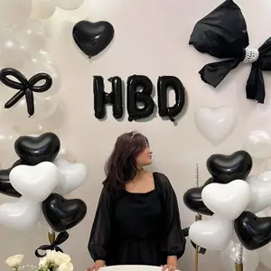 23-piece elegant black-and-white birthday party balloon decoration set, including a 16-inch black foil letter balloon spelling “HBD,” and 10-inch black-and-white heart-shaped foil balloons—ideal for birthday parties, coming-of-age celebrations