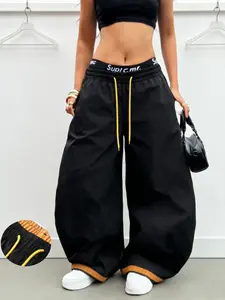 Streetwear Y2K hot‑girl high‑waisted drawstring wide‑leg pants with a bent‑blade silhouette that perfectly sculpts the leg line; color‑blocking with contrast drawstrings and small metal logo accents; color‑blocked cuffs; American street/wasteland style—of