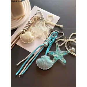 Coastal Starfish & Seashell Bag Charm Keychain, Ocean-Inspired Purse Accessory with Bow and Heart Pendant, Handmade Woven Lanyard Charm for Handbags, Backpacks and Car Keys, Beach Aesthetic Summer Accessory and Cute Gift for Women