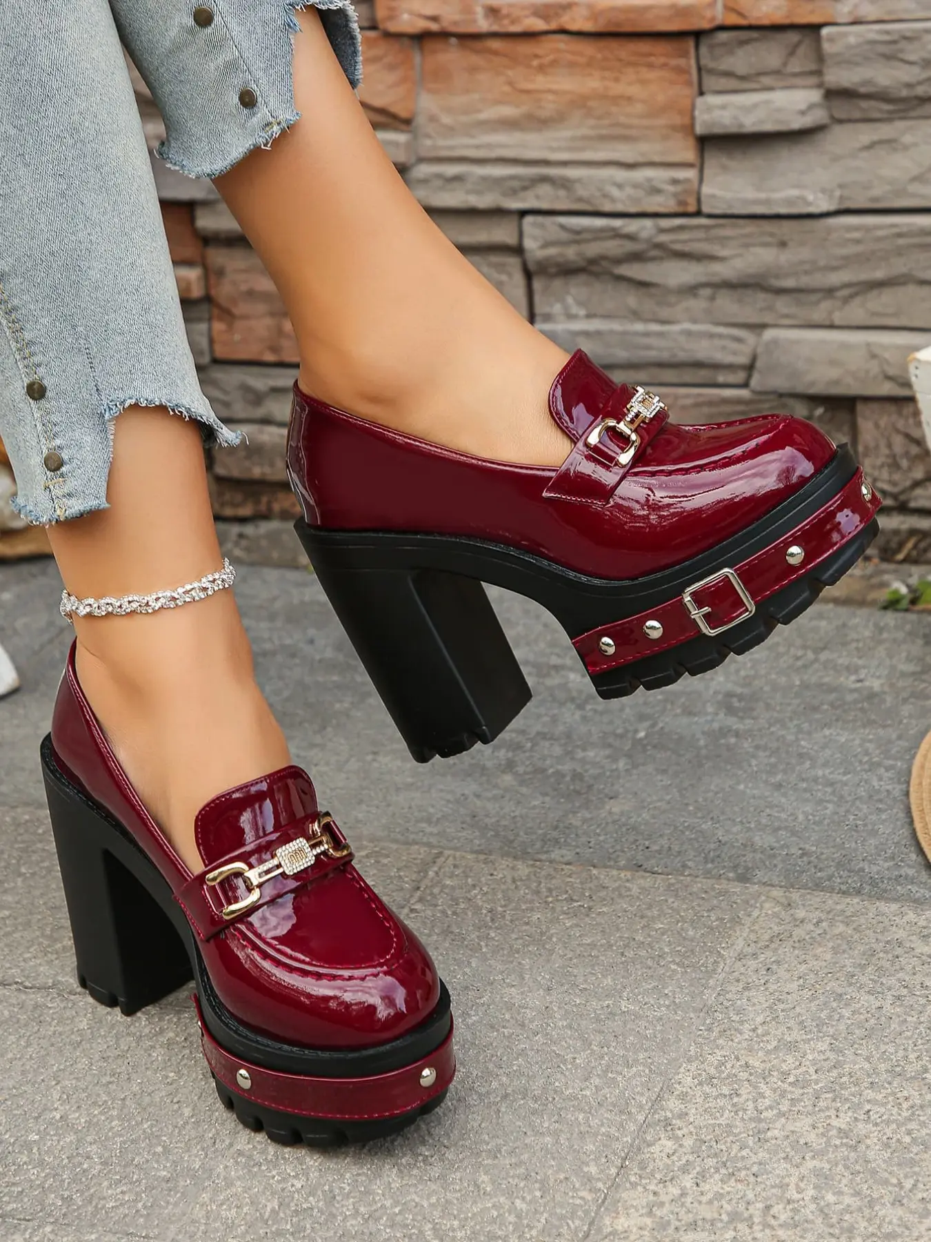 A pair of Women's Platform Block Heel Loafers, Patent Leather Upper, Chunky Studded Lug Sole, Rhinestone Buckle Accent, Edgy Platform Shoes, High Heel Loafers for Parties, Night Out, Street Style, Bold Footwear, Slip-On Design, Trendy Heeled Loafers