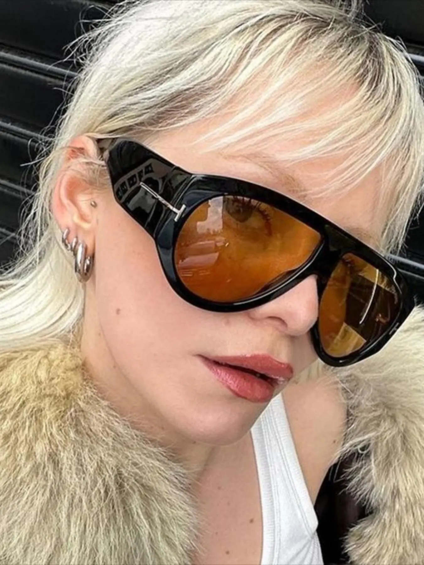 Model wearing oversized aviator sunglasses side view