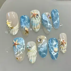 30Pcs summer beach press on nails in medium almond shape. Blue ocean French style with seashell acrylic texture. Gorgeous 3D cat eye effect, easy press design for charming seaside manicure.