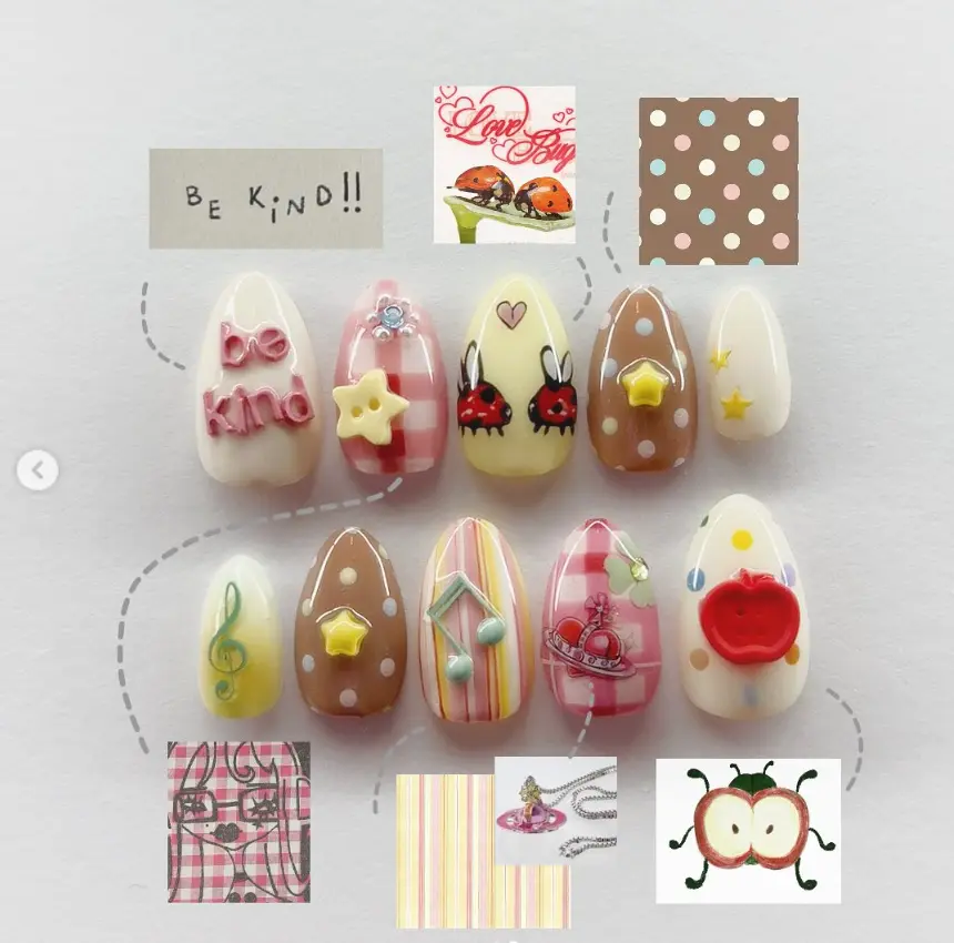 Adorable kawaii nails with playful 3D stars, music notes, ladybugs, and apples, featuring pastel stripes, polka dots, and a cute 'be kind' message