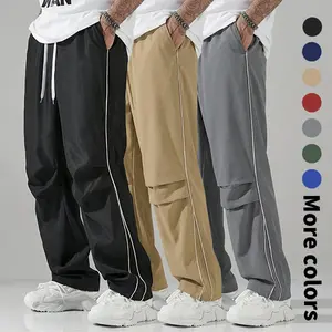 Men’s casual pants with a drawstring waist and pockets; black sweatpants; men’s black athletic pants; men’s black pants; men’s wide-leg pants with black stripes; autumn