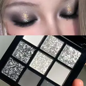 9-color smoky eyeshadow palette, including matte and shimmer shades in black, white, gray, and silver. High-pigment eyeshadow palette with 9 colors, suitable for gothic makeup, long-lasting glittery eyeshadow