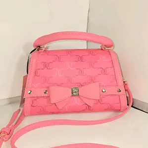 juicy Couture crossbody Pink Embossed Bow Handbag with Adjustable Strap and Gold Hardware