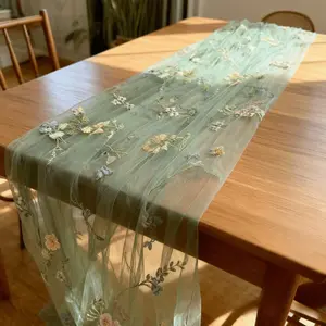 A Single Piece of Sage Green Tulle with Butterfly Floral Embroidery, Perfect for Romantic And Cozy Settings. This Sage Green Embroidered Tulle Table Runner Is Ideal for Anniversary Decorations on Rectangular Tables. It Features Only The Butterfly Fl