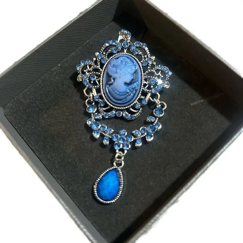 Beautiful Blue Pendant Necklace with Intricate Cameo Design and Sparkling Blue Gemstone Accents