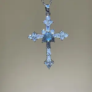 A cross necklace imbued with protective energy, featuring exquisitely set blue-white sapphires—a designer original that conveys a message of peace from Christian faith.