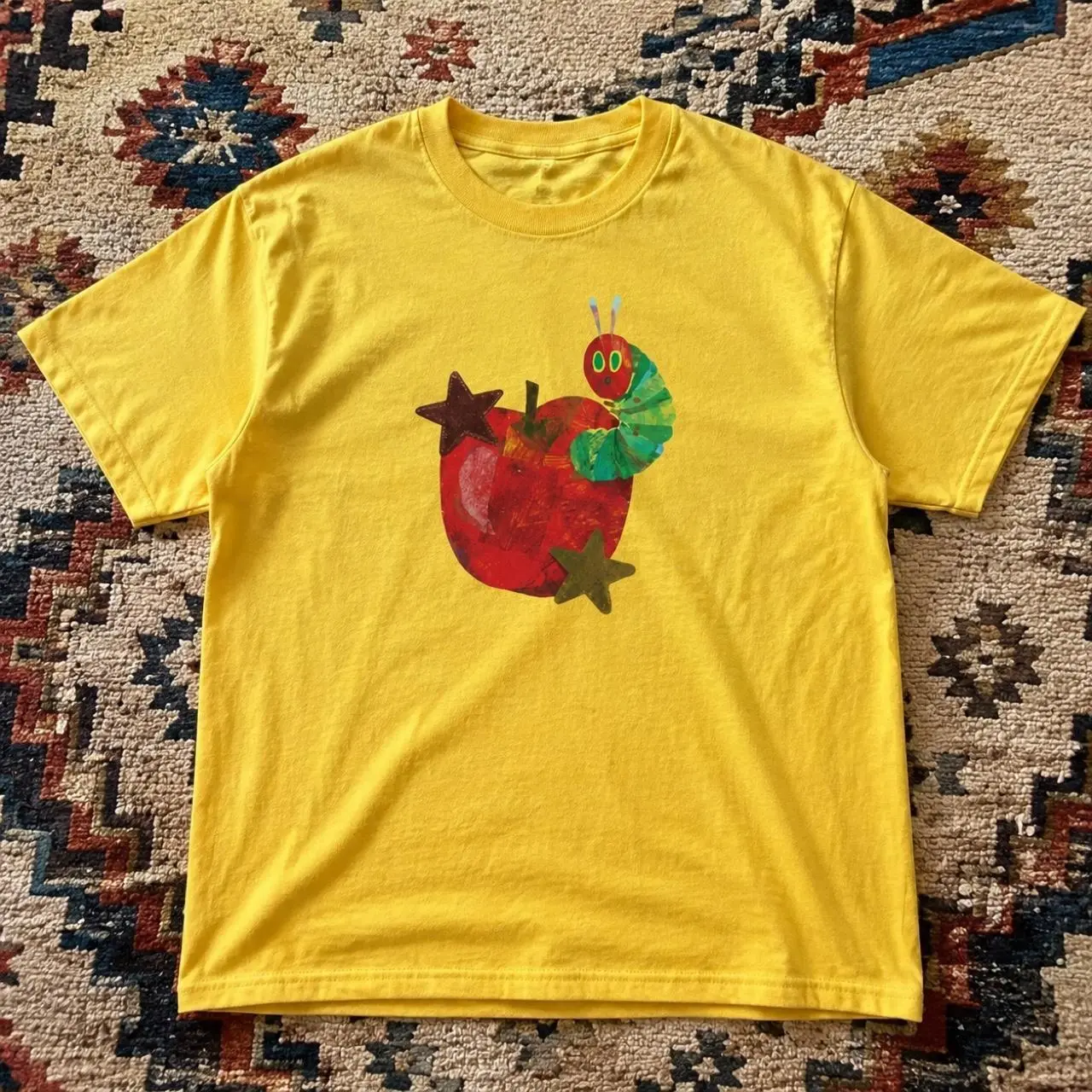 yellow t shirt with caterpillar graphic