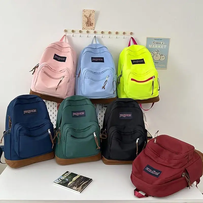Traditional JanSport School Backpack Soft Oxford Fabric Vintage Suede Bottom Detail Spacious Main Compartment Adjustable Shoulder Straps Casual Travel Bookbag For Students