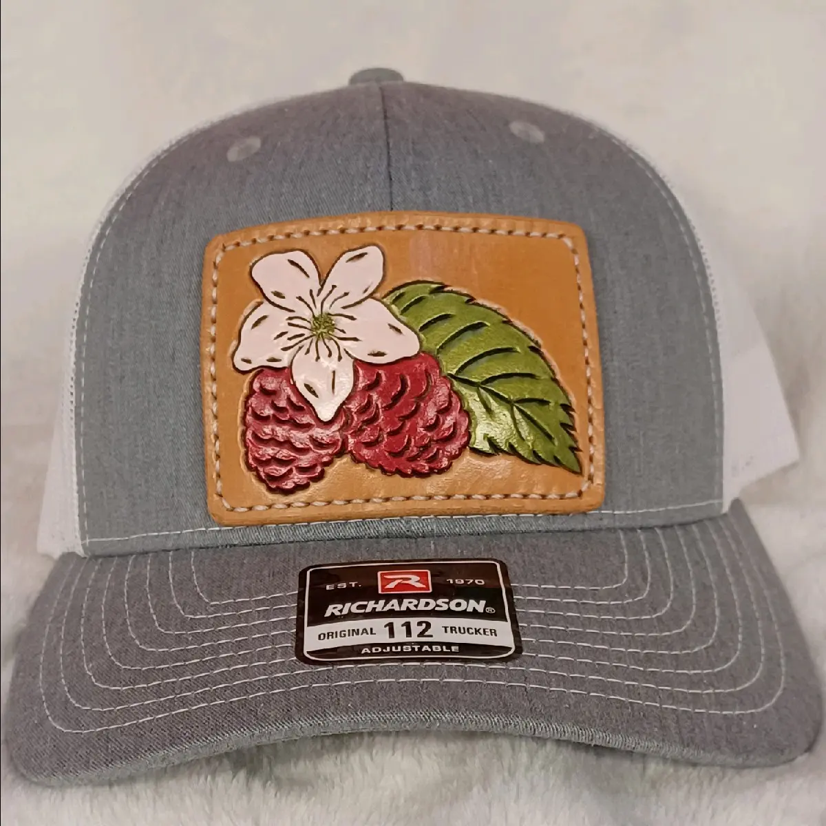 Raspberry Blossom Leather Patch sewed on baseball hat