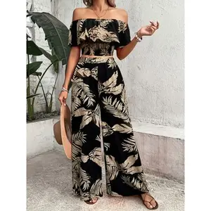 Women’s two-piece set featuring a black palm leaf print: a short floral shoulder top and wide-leg pants. A lightweight vacation-style ensemble, ideal for tropical getaways, beachwear, light afternoon teas, and casual streetwear. GARMENTARY