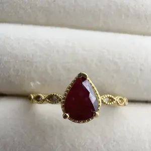 <PingEast jewelry > Ruby ring401----Elegant with a twist — this 925 sterling silver ring showcases a pear-shaped 5×7mm natural Burmese pigeon blood ruby, set in a sleek four-prong gold-tone setting with a braided band. Includes certificate of authenticity