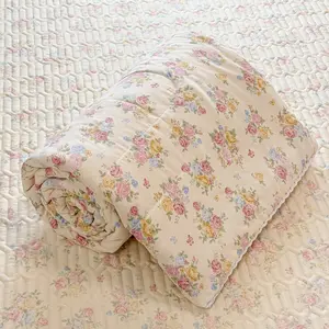 A French Vintage-Style Summer Quilt featuring a Rose Floral Pattern and Lace Trim—a soft, breathable, and lightweight summer blanket ideal for use in the bedroom, office, living room, or for general home relaxation during the warmer months