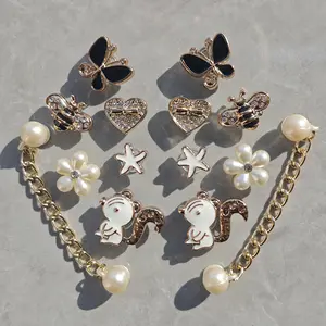 Niche aesthetic squirrel clog accessory set with butterfly, heart, rhinestone and floral designs, including shoe buckles and chain decorations. Shoes not included, charms only