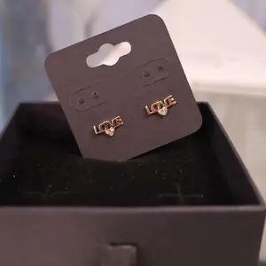 10kt Gold “LOVE” Stud Earrings with Sparkling Stone.